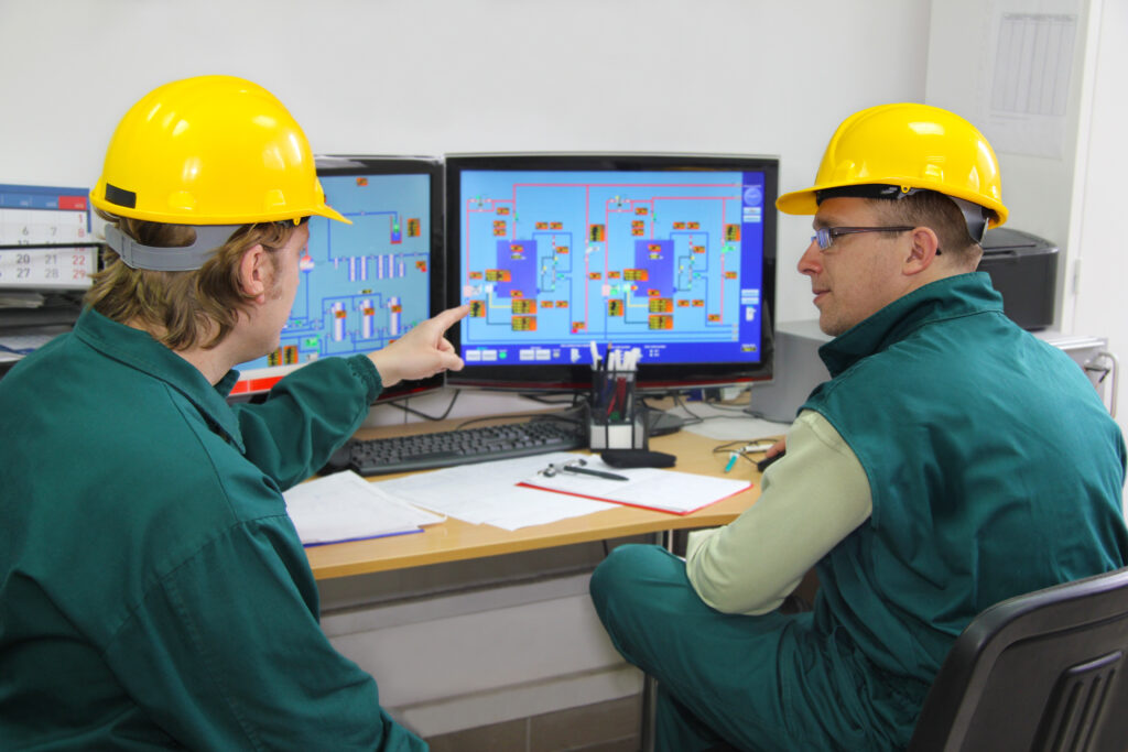 Industrial workers in control room